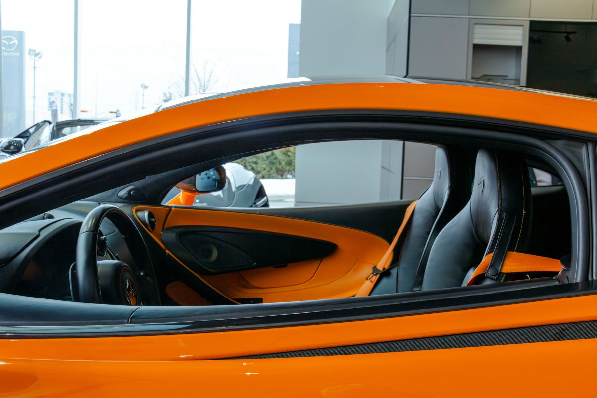 orange sports car at automotive dealership