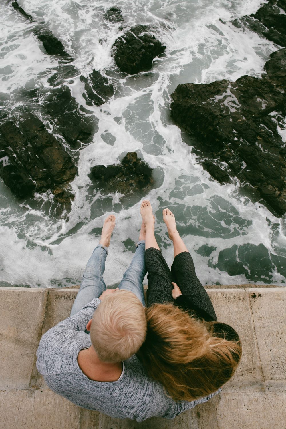 middle aged couple sitting by water